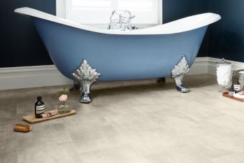 blue clawfoot bath with light grey stone tiled vinyl bathroom flooring